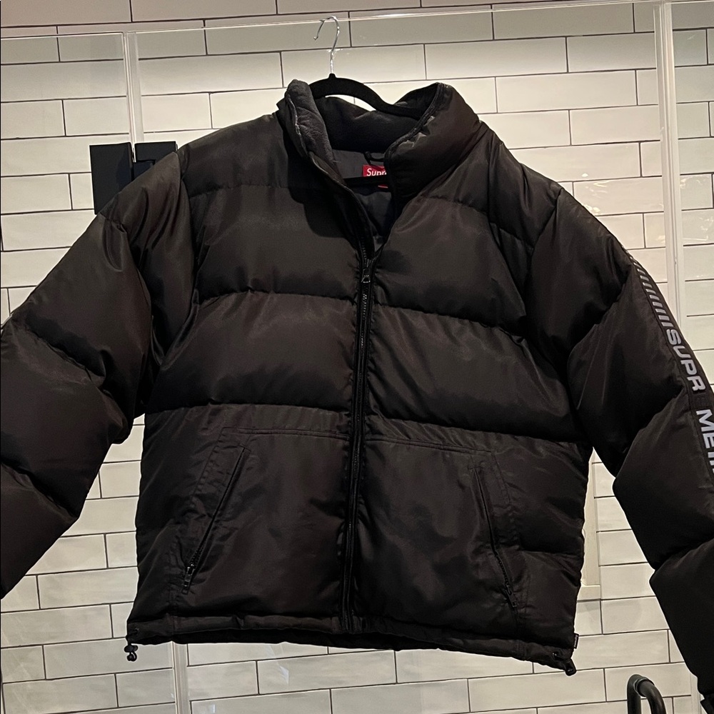 Supreme black puffer coat with reflective accents